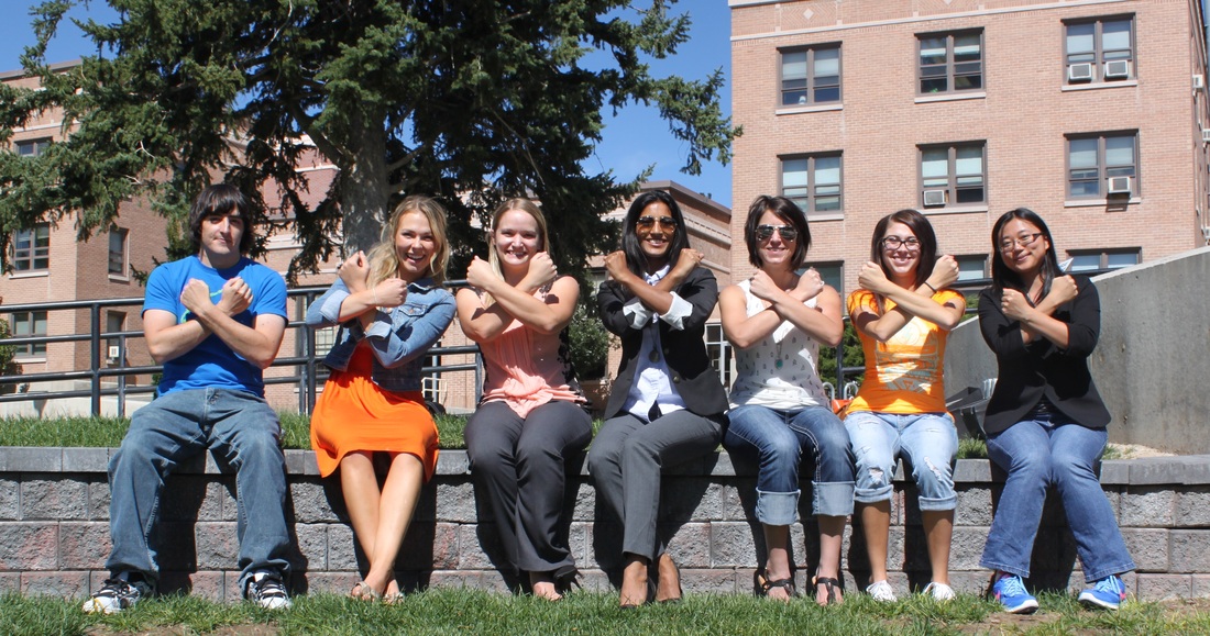 Picture of the lab all making Xs with their arms. (from left): Travis, Dani, Emily, Jabeene, Sam, Ashley, Professor X