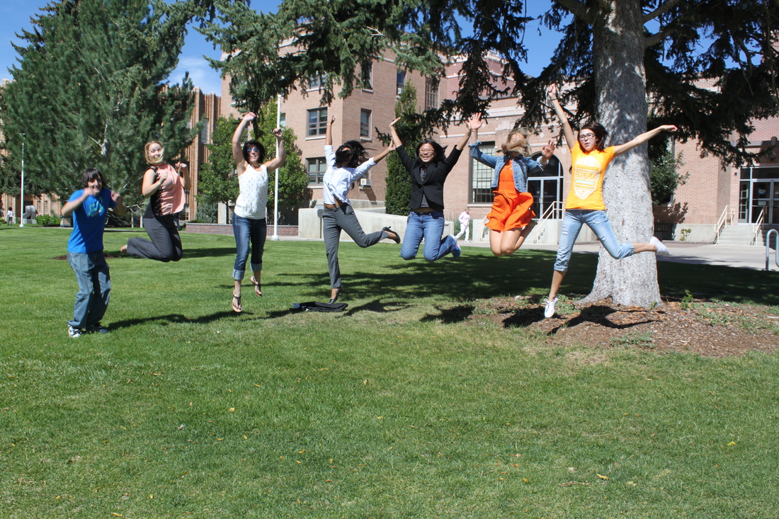 Picture of the lab, everyone is jumping. (from left): Travis, Emily, Sam, Jabeene, Dr. Xu, Dani, Ashley